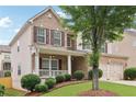 Charming two-story home with brick and siding, a covered porch, and a well-maintained lawn at 230 Collins View Ct, Lawrenceville, GA 30043