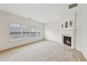Bright and airy living room with a fireplace, carpet flooring, and lots of natural light at 230 Collins View Ct, Lawrenceville, GA 30043