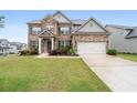 Charming two-story brick home featuring a lush green lawn and welcoming curb appeal at 2537 Sori Dr, Buford, GA 30519