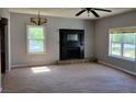 Bright living room featuring a decorative fireplace and ample natural light at 7217 Union Grove Rd, Lithonia, GA 30058