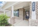 Inviting front porch featuring brick columns and a view of the front door at 160 Amherst Way, Fayetteville, GA 30215