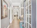 Hallway features hardwood floors, decorative accents, and an open view to the living spaces at 160 Amherst Way, Fayetteville, GA 30215