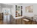 Bright foyer with a built-in bookcase and hardwood floors leading into a dining room at 3585 Roxboro Ne Rd # 2, Atlanta, GA 30326