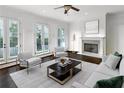 Cozy living room with a fireplace, French doors, and a ceiling fan at 3585 Roxboro Ne Rd # 2, Atlanta, GA 30326