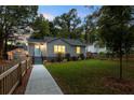 Quaint home with inviting front lawn, showcasing mature trees and charming curb appeal at 1583 Braeburn Se Dr, Atlanta, GA 30316