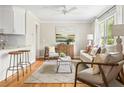 Sunlit living room with hardwood floors, neutral tones, and stylish furnishings, creating an inviting space at 1583 Braeburn Se Dr, Atlanta, GA 30316