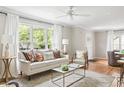 Bright and airy living room featuring large windows, a neutral color palette, and hardwood floors at 1583 Braeburn Se Dr, Atlanta, GA 30316
