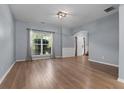 Bright living room featuring hardwood floors, a large window, and an open entryway at 211 Augusta Woods Dr, Villa Rica, GA 30180
