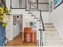 Traditional foyer with hardwood floors, staircase with black and white trim, and a charming antique desk at 4792 Fairville Ct, Marietta, GA 30062