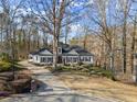Aerial view of a charming single-Gathering home surrounded by a lush, mature landscape, offering privacy and curb appeal at 6170 Wellington Ct, Cumming, GA 30040