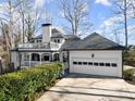 Rear exterior view featuring a spacious deck and patio areas, perfect for outdoor entertaining and relaxation at 6170 Wellington Ct, Cumming, GA 30040