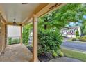 Inviting front porch with stone flooring and lovely garden views at 123 Patrick Way, Marietta, GA 30064