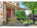 Welcoming covered front porch with stone accents and manicured landscaping at 123 Patrick Way, Marietta, GA 30064