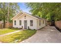 Beautiful single-story home with a concrete driveway and lush green lawn at 2294 Hill Nw St, Atlanta, GA 30318