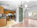 Open-concept living area featuring hardwood floors, modern lighting, and seamless transition to the kitchen at 3599 Salem Glen Rd, Lithonia, GA 30038