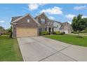 Attractive home featuring a brick facade, a well-maintained lawn, and a spacious driveway at 7190 Tributary Ct, Cumming, GA 30040