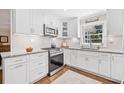 Bright, updated kitchen featuring white cabinets, subway tile backsplash, and granite countertops at 755 Monticello Se Way, Marietta, GA 30067