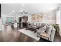 Open-concept living space with hardwood floors, modern furnishings, and abundant natural light at 2022 Talmai Dr, Snellville, GA 30078