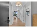 Inviting hallway with light wood floors and bright white walls leading to a living area at 2425 Peachtree Ne Rd # 902, Atlanta, GA 30305