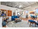 Cozy living room features a comfortable blue sofa, area rug, and adjacent kitchen and dining area at 5097 Peachtree Rd # I, Atlanta, GA 30341