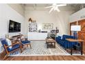 Comfortable living room area with a blue sofa, patterned rug, and ample space for relaxation and entertainment at 5097 Peachtree Rd # I, Atlanta, GA 30341