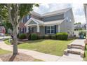 Charming home on a corner lot features lush lawn, sidewalk and appealing curb appeal at 577 Cypher Drive, Suwanee, GA 30024