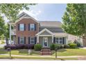 Inviting two-story home with brick and siding, features manicured landscaping and an appealing facade at 577 Cypher Drive, Suwanee, GA 30024
