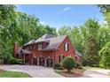 Expansive brick home featuring a three-car garage and a spacious backyard, offering ample space and privacy at 63 Lewellen Dr, Marietta, GA 30064
