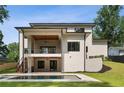 Stunning modern home exterior featuring a covered deck, backyard pool, and a private outdoor oasis at 3293 Lenox Ne Pl, Atlanta, GA 30324