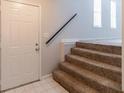 Inviting entryway with tiled floors, a staircase, and a neutral color palette at 3851 Natalie Way, Ellenwood, GA 30294