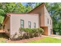 Home featuring a stone foundation, a garage, mature trees, and an inviting facade at 3851 Natalie Way, Ellenwood, GA 30294