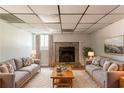 Cozy living room with a stone fireplace, plush rug, and comfortable seating arrangement at 3851 Natalie Way, Ellenwood, GA 30294
