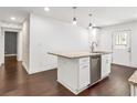 Modern kitchen with granite countertop island, stainless steel dishwasher, and stylish pendant lighting at 644 Albert Nw St, Atlanta, GA 30318