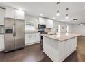 Open kitchen featuring white cabinets, stainless steel appliances, and a large island with granite countertops at 644 Albert Nw St, Atlanta, GA 30318