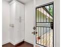 Clean mud room featuring a built-in cabinet and a black metal security door leading to the back yard at 644 Albert Nw St, Atlanta, GA 30318