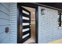 Open modern black front door with frosted glass panels showcasing the home's interior and new floors at 1120 Taliwa Ne Trl, Marietta, GA 30068