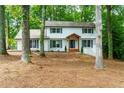 Inviting two-story home with brick facade, complemented by a charming front porch and lush greenery at 280 E Valley Dr, Marietta, GA 30068