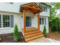 Charming front porch with wooden beam accents and a freshly painted white brick facade at 280 E Valley Dr, Marietta, GA 30068