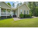Well-maintained home with a inviting front porch, landscaping, and walkway at 380 Russell Rd, Lawrenceville, GA 30043