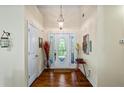 Bright foyer with hardwood floors, decorative lighting and arched front door at 380 Russell Rd, Lawrenceville, GA 30043