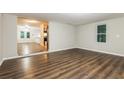 Spacious living room featuring hardwood floors, neutral paint, and a seamless open layout at 6480 Port A Prince Drive Dr, Forest Park, GA 30297