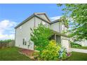 Charming two-story home with a covered porch and a manicured lawn at 2166 Villa Spring Ct, Dacula, GA 30019
