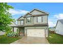 Two-story home with a two-car garage, welcoming covered porch, and manicured lawn at 2166 Villa Spring Ct, Dacula, GA 30019