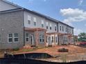 New townhomes featuring brick and siding exteriors, private patios with pergolas, and lawn preparation at 3102 Marbella Cir # 1, Kennesaw, GA 30152