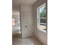 Bright hallway with fresh white walls and trim, featuring a storage closet and natural light through the window at 3102 Marbella Cir # 1, Kennesaw, GA 30152