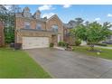 Beautiful two-story brick house with a lush green lawn and a double garage at 7027 Walham Grv, Duluth, GA 30097