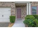 Close-up of the front door, showcasing the brickwork, tiled walkway, and landscaping at 7027 Walham Grv, Duluth, GA 30097