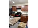 Kitchen with cabinets, range, island with sink, and countertop space at 2080 Belmont Cir, Conyers, GA 30012