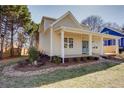 A bright-colored house with a covered front porch and brick landscaping details at 3286 Bachelor Street, East Point, GA 30344