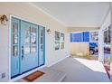 Cozy front porch with a light blue door framed by glass sidelights and matching light fixtures at 3286 Bachelor Street, East Point, GA 30344